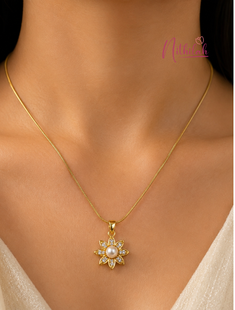 Woman wearing an anti-tarnish gold pearl flower pendant necklace featuring sparkling crystal petals.