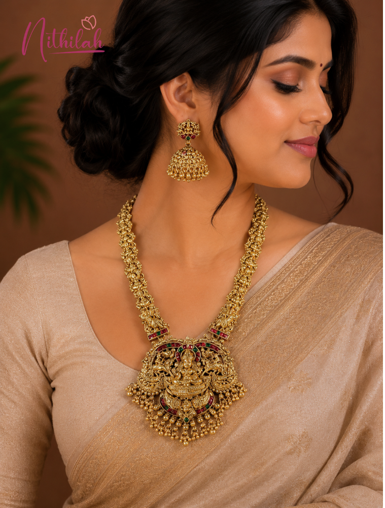 Woman wearing Antique Gold Finish Lakshmi Pendant Necklace with Ruby Pink Stones