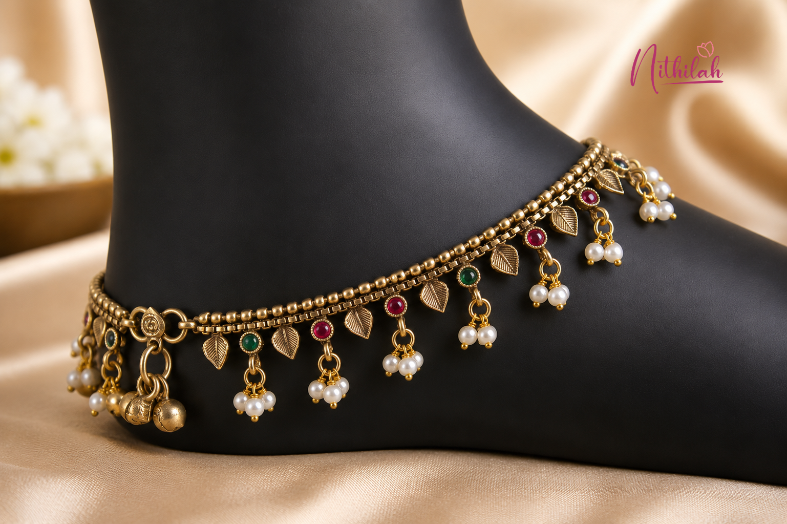 Close up details of Antique Gold Finish Traditional Anklet  with red and green stones and pearl drops for women, perfect for weddings, festivals and ethnic wear.