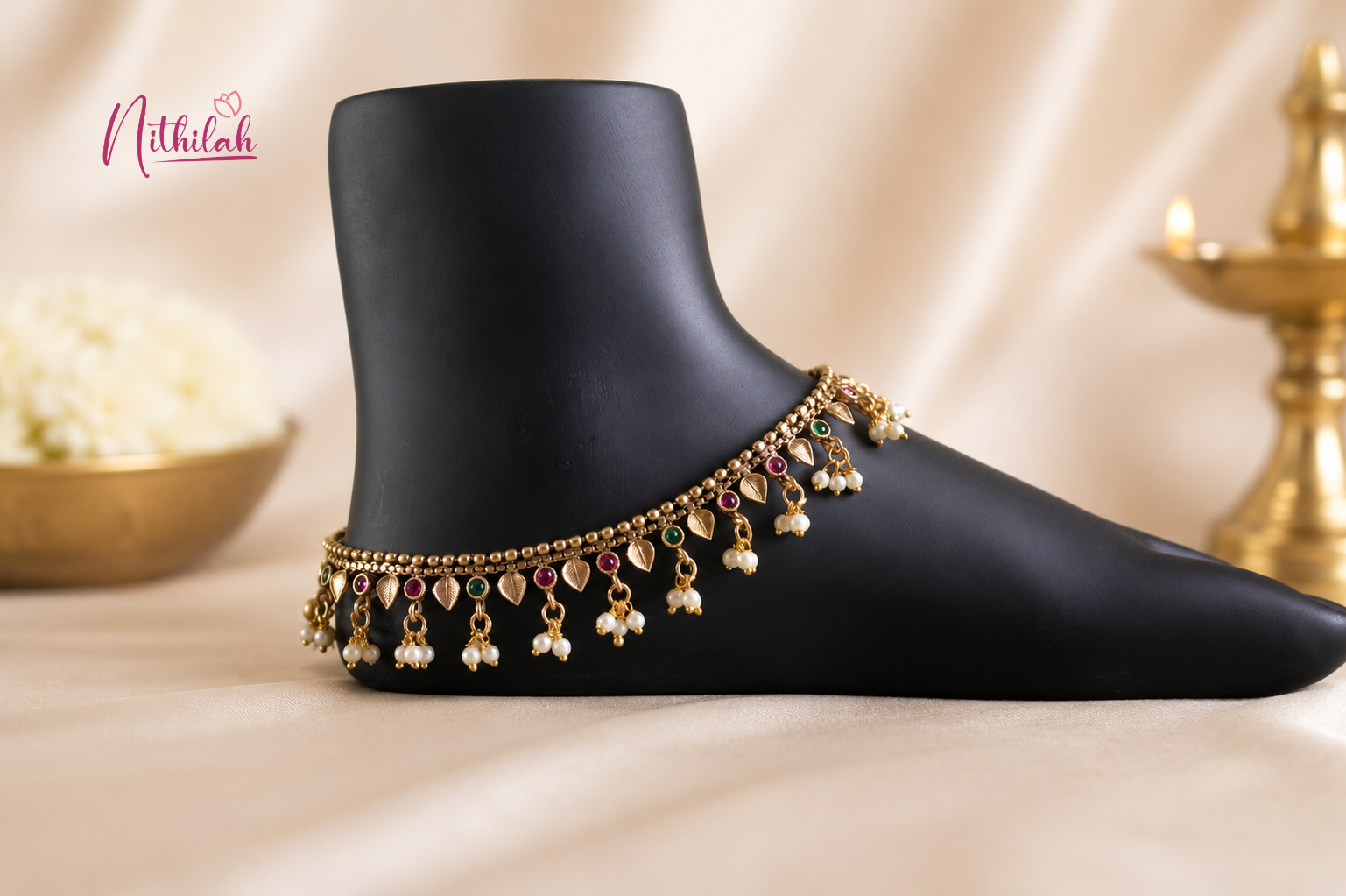 Antique Gold Finish Traditional Anklet with red and green stones and pearl drops for women, perfect for weddings, festivals and ethnic wear.