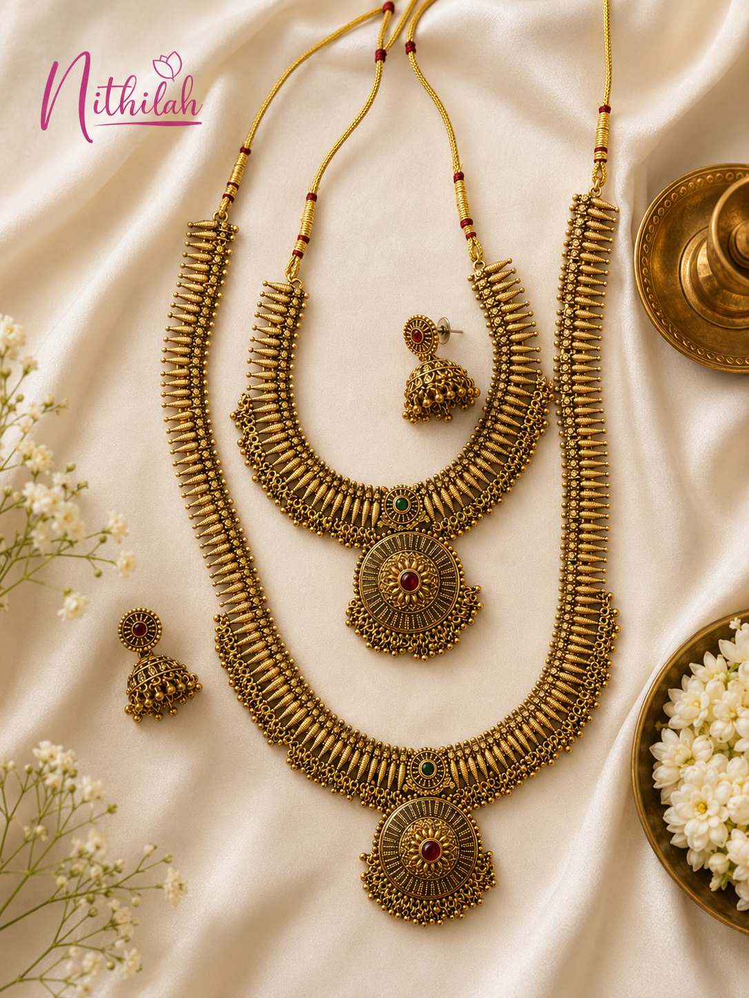 Premium Antique Gold Finish Traditional Short & Long Necklace Set with matching Jhumka Earrings elegantly displayed on a luxury silk background with traditional styling.