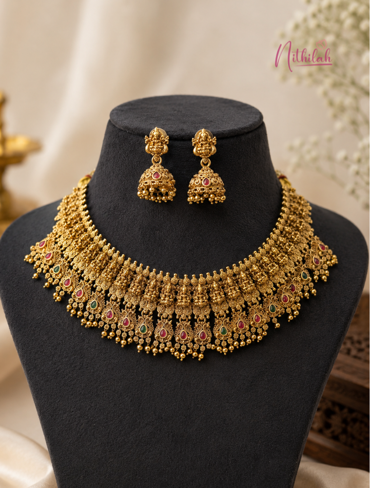 Antique Gold Finish Lakshmi Temple Choker Necklace Set with Matching Lakshmi Jhumka Earrings displayed on a black velvet jewellery bust