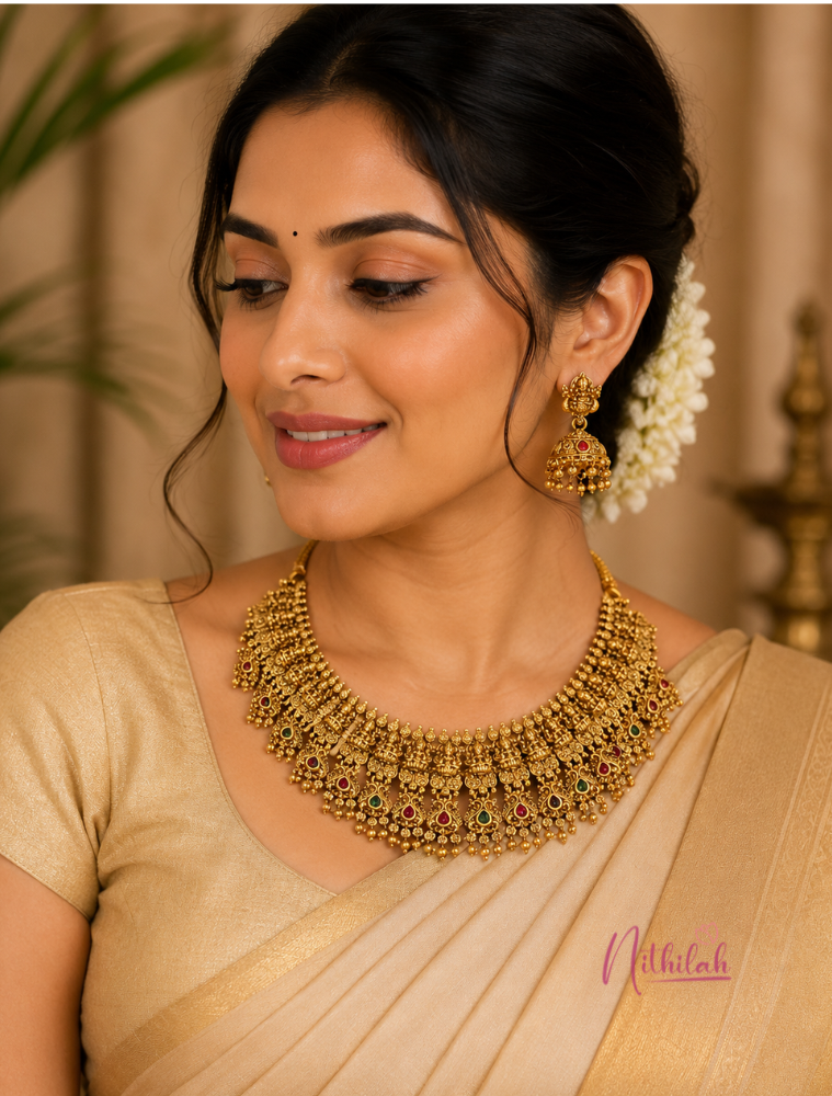 South Indian model wearing an Antique Gold Finish Lakshmi Temple Choker Necklace Set with Matching Lakshmi Jhumka Earrings