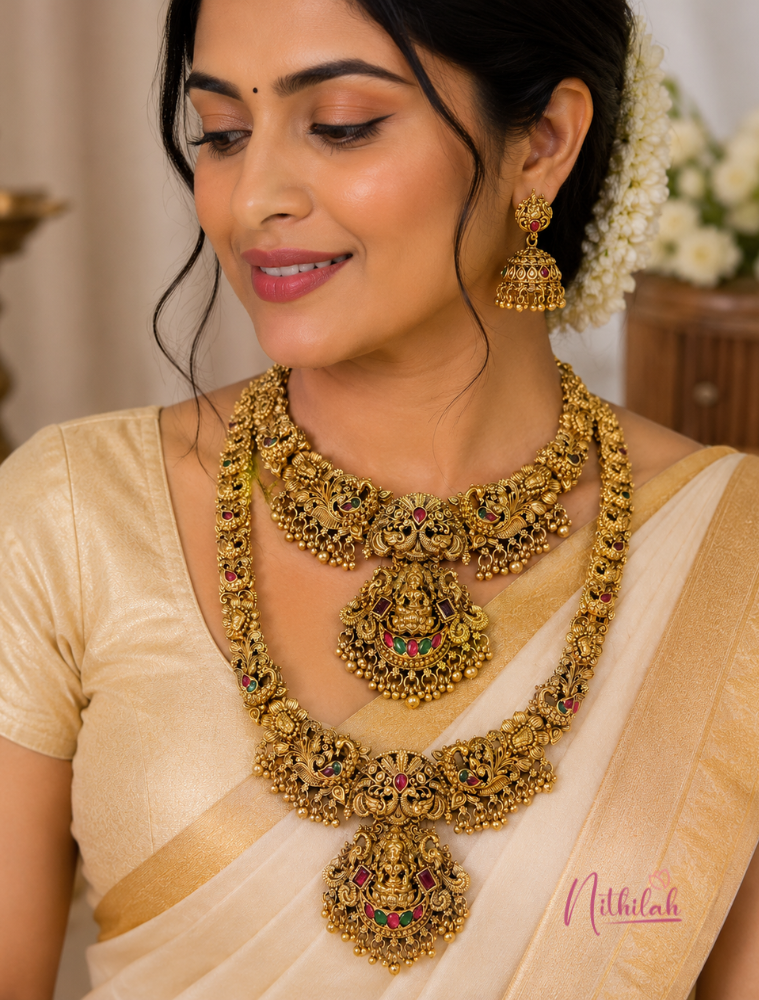 South Indian model wearing an Antique Gold Finish Lakshmi Temple Short Necklace and Long Haram Set with Matching Lakshmi Jhumka Earrings.
