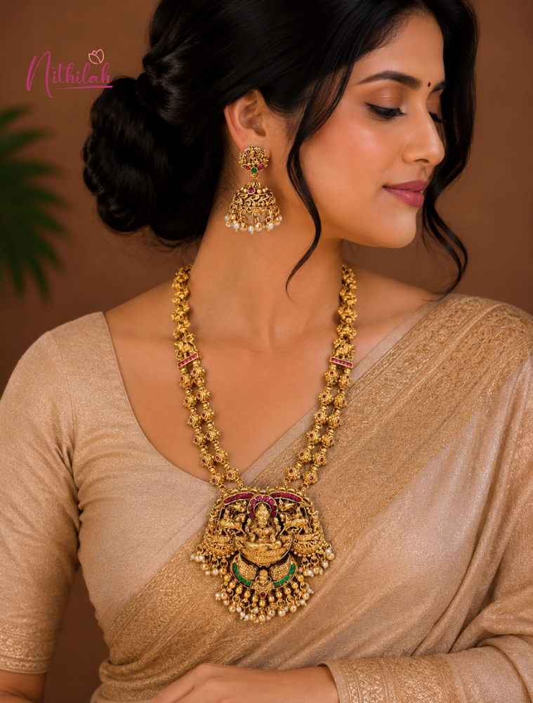 Woman wearing Gold Finish Lakshmi Double Layer Temple Haaram with Ruby Pink Stones,Green Accents and Matching Jhumka Earrings
