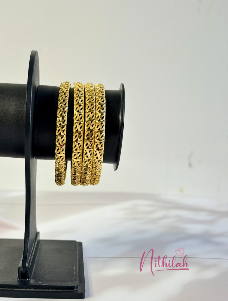 Gold Plated Designer Daily Wear Kids Bangles Set of 4 with intricate traditional cutwork design displayed on a stand.