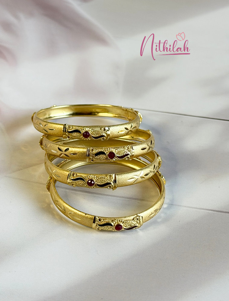 Gold plated traditional kids bangles with ruby stone detailing, matte finish and floral engraved design for girls