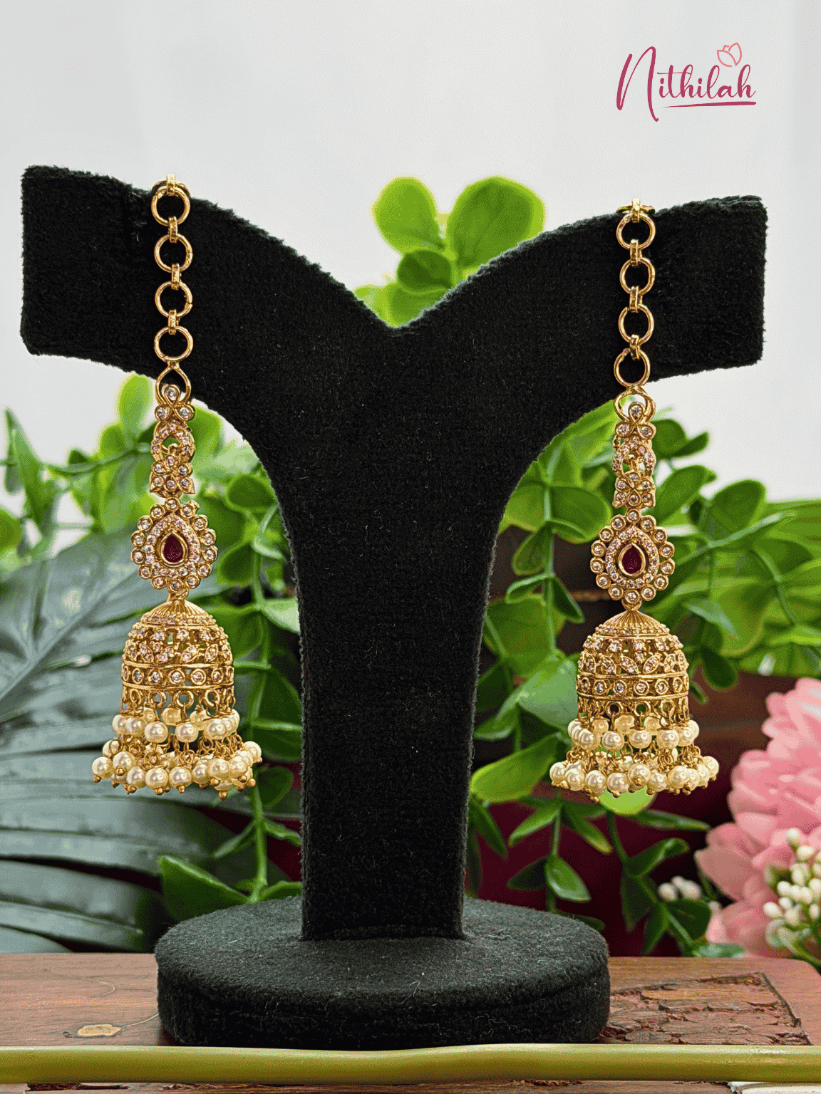 Gold tone CZ long jhumka earrings with mattal, red stone detailing and pearl drops