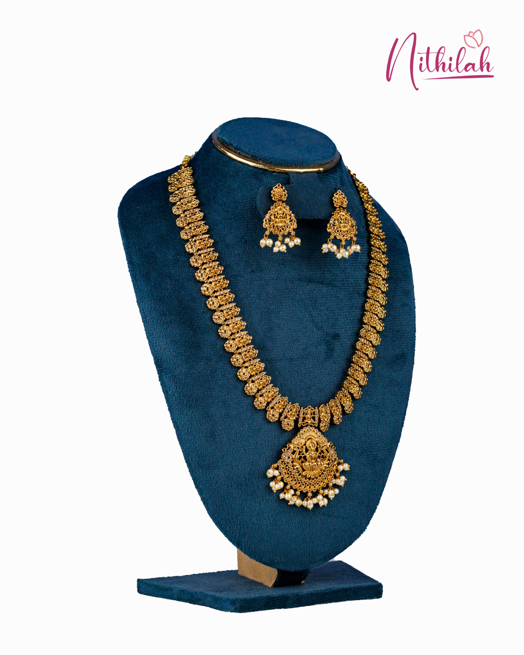 Angled view of antique Lakshmi haaram with decorative links, pearl-drop edging and matching earrings