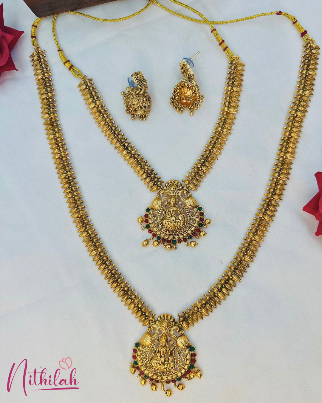 Lakshmi temple haaram and short necklace laid flat with matching jhumkas, leaf-shaped elements and adjustable yellow threads