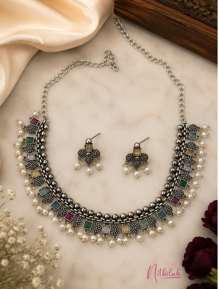 Premium oxidised silver multicolour stone necklace set with pearl drops and matching earrings displayed elegantly.