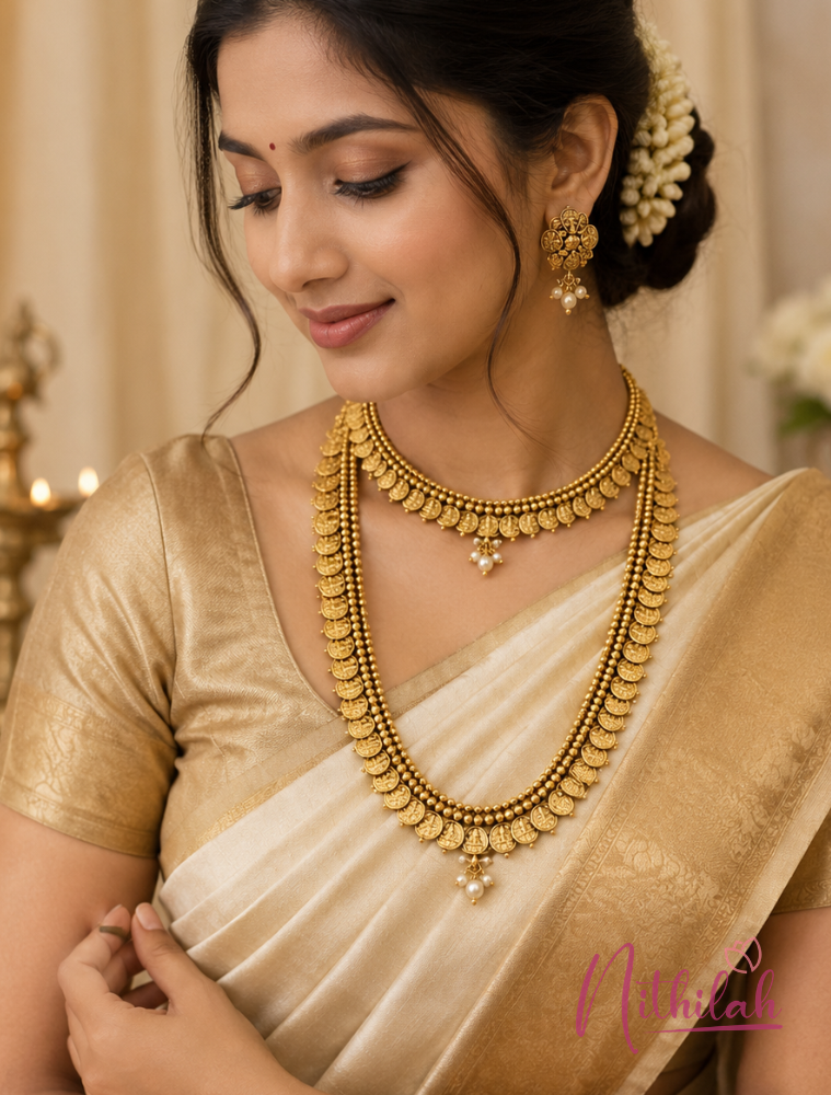 South Indian model wearing Traditional Gold Finish Kaasu Malai Necklace Set with matching earrings and cream silk saree for bridal styling.